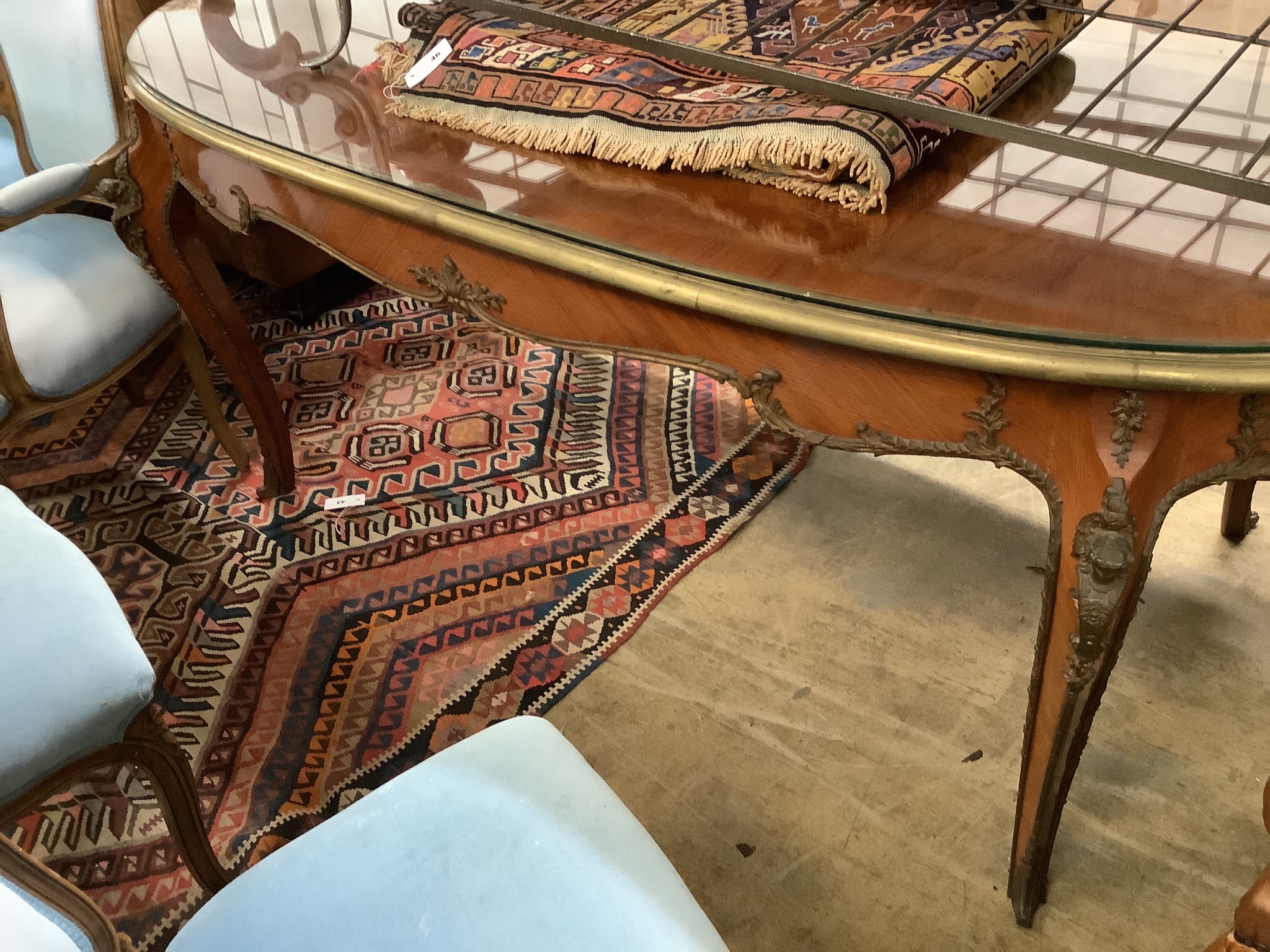 An oval gilt metal mounted Continental dining table, length 200cm, width 100cm, height 78cm